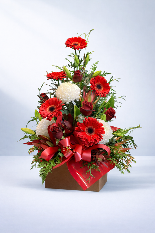 Red gerberas and roses arranged with white chrysanthemums in a gift box, created by Emflowerment florist Croydon with same-day delivery available.