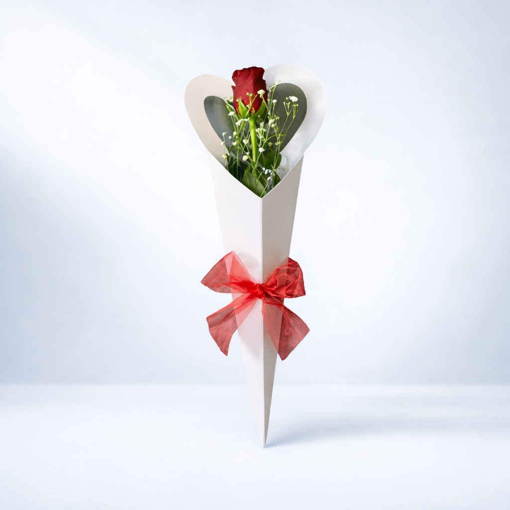 Red Rose wrapped in white paper with a red bow on a light gray background for valentines day from Emflowerment Croydon