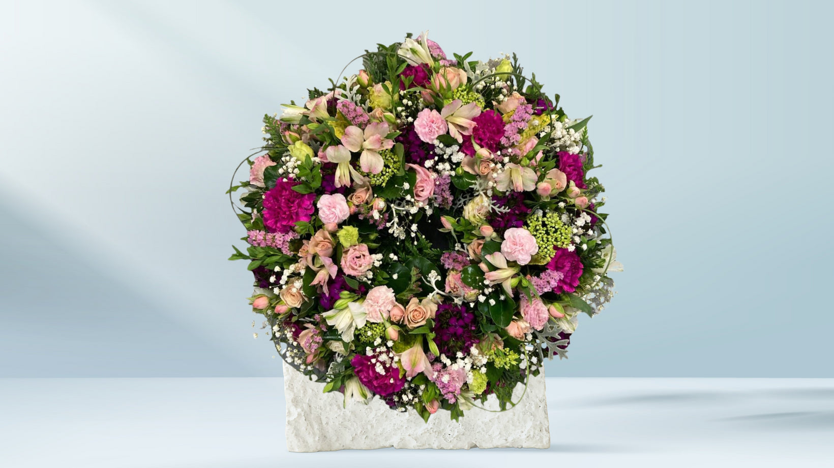 Handcrafted funeral wreath featuring seasonal flowers, available for Croydon funeral and memorial delivery by Emflowerment.