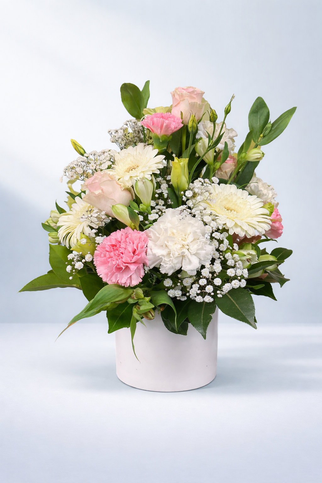 Fresh white and pink flower arrangement with roses, gerberas, carnations and babies breath in a white vase from Emflowerment Florist Croydon, offering delivery to surrounding suburbs.