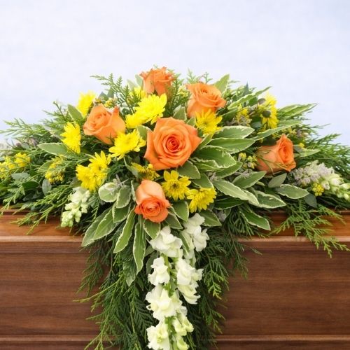 Beautiful funeral spray arrangement designed with fresh blooms and foliage, suitable for funerals, memorials, and celebration-of-life services.
