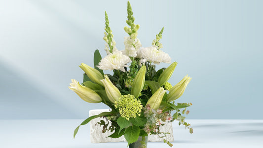 Bouquet of white and green flowers on a light blue background